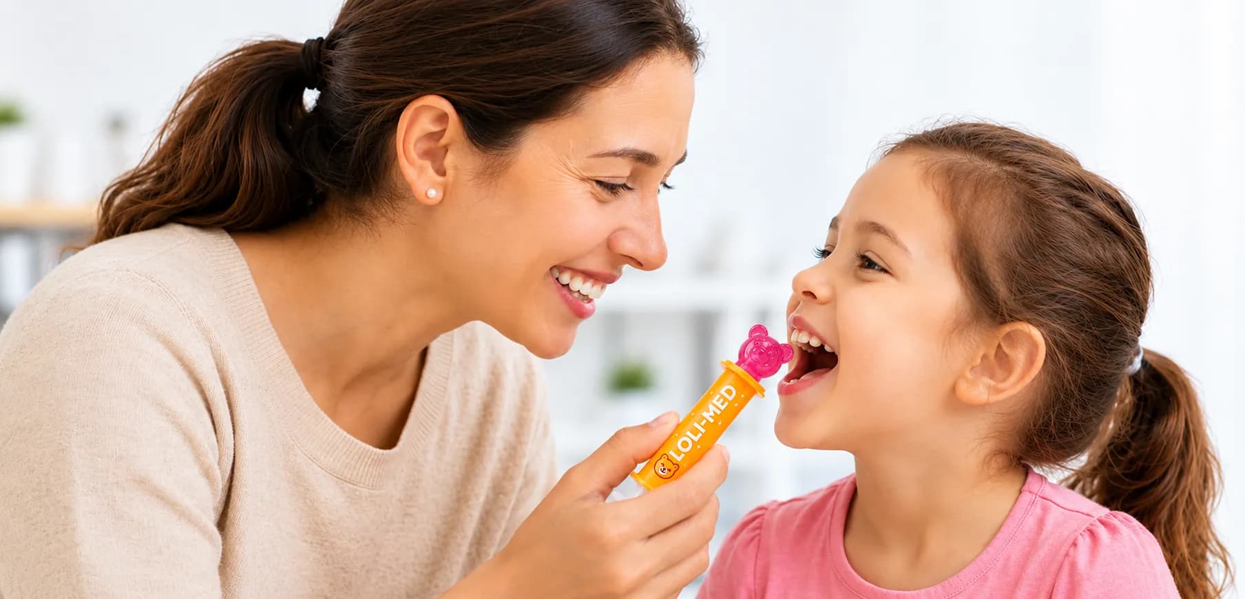 Parent and child smiling while using Loli-Med together